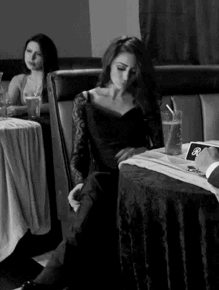 A girl pulls up her dress and flashes her pussy in a restaurant Gif.