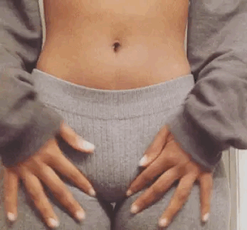 A girl in yoga pants feels round her vagina Gif 