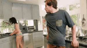 A man gets caught by his girlfriend getting a sneaky blowjob in the kitchen Gif 