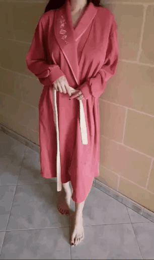 A woman in a bathrobe opens it up to reveal her sexy naked body.