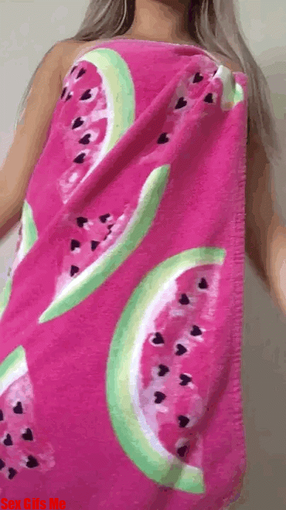 A girl jiggles her watermelon towel off to show her fabulous naked body underneath.