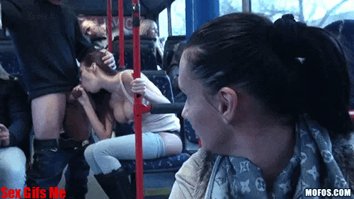 A girl watches another girl give a blow job to a man on a public bus.