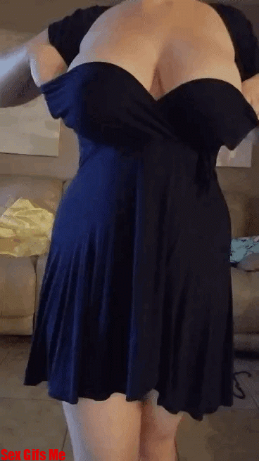 A girl slips out of her formal dress to show you her big boobs.